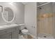 Modern bathroom with a single vanity, a toilet and a shower with marble-look tiles and glass doors at 144 Grayland Hills Ct, Lawrenceville, GA 30046