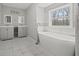 Bright bathroom with double vanity, soaking tub, and modern fixtures, creating a spa-like atmosphere at 144 Grayland Hills Ct, Lawrenceville, GA 30046