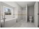 Bright bathroom with modern tub, separate shower, and stylish tile accents at 144 Grayland Hills Ct, Lawrenceville, GA 30046