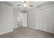 Bedroom features neutral tones, carpet, ceiling fan, and closet at 144 Grayland Hills Ct, Lawrenceville, GA 30046