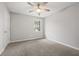 Bedroom features neutral tones, carpet, ceiling fan, and ample natural light at 144 Grayland Hills Ct, Lawrenceville, GA 30046