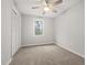 Bedroom features neutral tones, carpet, ceiling fan, and ample natural light at 144 Grayland Hills Ct, Lawrenceville, GA 30046
