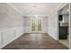 Bright dining room with wainscoting, elegant lighting, and modern flooring, creating an inviting space at 144 Grayland Hills Ct, Lawrenceville, GA 30046