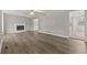 Open-concept living room with a fireplace, modern flooring, and neutral paint, creating a cozy and inviting space at 144 Grayland Hills Ct, Lawrenceville, GA 30046