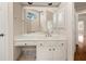 Bathroom with a window, custom cabinets, and a large mirror at 3287 Belmont Glen Se Dr, Marietta, GA 30067