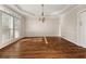Formal dining room with hardwood floors, decorative lighting, and large windows at 3287 Belmont Glen Se Dr, Marietta, GA 30067