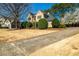Charming two-story home with well-manicured landscaping, mature trees, and a curved driveway at 3287 Belmont Glen Se Dr, Marietta, GA 30067