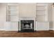 Close up view of the living room's fireplace with black marble hearth and white custom built-ins at 3287 Belmont Glen Se Dr, Marietta, GA 30067