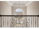 Foyer with wrought iron railing, chandelier, arched window and abundant natural light at 3287 Belmont Glen Se Dr, Marietta, GA 30067