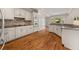 Spacious kitchen with white cabinetry, granite countertops, stainless steel appliances, and hardwood floors at 3287 Belmont Glen Se Dr, Marietta, GA 30067