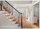 Ornate wrought iron staircase and hardwood floors leading from the main foyer of the home at 3287 Belmont Glen Se Dr, Marietta, GA 30067