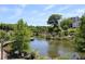 Serene pond with lush trees and landscaping, creating a peaceful environment at 620 Glen Iris Ne Dr # 318, Atlanta, GA 30308