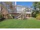 This is a backyard showcasing a home's rear elevation with a covered deck and well-manicured lawn at 1728 Holcomb Lake Rd, Marietta, GA 30062