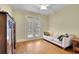 Cozy bedroom featuring hardwood floors, a sofa, and double doors to the outside at 1728 Holcomb Lake Rd, Marietta, GA 30062