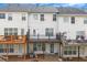 Back of townhouses, featuring decks and patios at 1868 Appaloosa Mill Ct, Buford, GA 30519