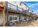 Rear view of townhouses with decks, patios, and a small lawn at 1868 Appaloosa Mill Ct, Buford, GA 30519