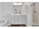 Bathroom featuring double sinks, separate tub, shower, and modern lighting at 1868 Appaloosa Mill Ct, Buford, GA 30519