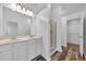 Bathroom featuring double sinks, walk-in shower, and bright lighting at 1868 Appaloosa Mill Ct, Buford, GA 30519