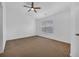 Spacious bedroom with a ceiling fan and a large window, offering a bright and airy feel at 1868 Appaloosa Mill Ct, Buford, GA 30519