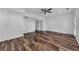 Spacious bedroom featuring wood-look floors, a ceiling fan, and ample natural light at 1868 Appaloosa Mill Ct, Buford, GA 30519