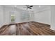 Bright bedroom featuring wood floors, a ceiling fan, and a sliding glass door at 1868 Appaloosa Mill Ct, Buford, GA 30519