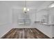 Bright dining area featuring modern lighting, wood floors, and a large window at 1868 Appaloosa Mill Ct, Buford, GA 30519