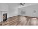 Inviting living room with wood floors, a cozy fireplace, and a large window at 1868 Appaloosa Mill Ct, Buford, GA 30519