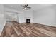 Bright living room featuring wood floors, a fireplace, and open access to the kitchen at 1868 Appaloosa Mill Ct, Buford, GA 30519