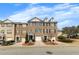 Attractive townhomes with individual driveways and manicured front yards along a well-maintained street at 1868 Appaloosa Mill Ct, Buford, GA 30519