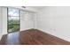 Bright bedroom with hardwood floors, large window with a city view, and a modern decorative mirror at 375 Ralph Mcgill Ne Blvd # 807, Atlanta, GA 30312