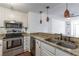 Modern kitchen features stainless steel appliances, granite countertops, and beautiful pendant lighting, with a breakfast bar at 375 Ralph Mcgill Ne Blvd # 807, Atlanta, GA 30312