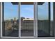 Condo balcony view shows a beautiful cityscape through open sliding doors at 855 Peachtree Ne St # 2912, Atlanta, GA 30308