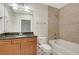 Well-lit bathroom with tub, shower, tile surround, and wooden vanity at 855 Peachtree Ne St # 2912, Atlanta, GA 30308