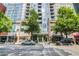 Street view of a modern building with shops, apartments, and street parking at 855 Peachtree Ne St # 2912, Atlanta, GA 30308