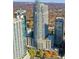 Stunning aerial view of high-rise condos with rooftop pool and lush green landscaping at 855 Peachtree Ne St # 2912, Atlanta, GA 30308