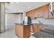 Modern kitchen with stainless steel appliances, granite countertops, and wooden cabinets at 855 Peachtree Ne St # 2912, Atlanta, GA 30308