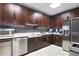 Modern kitchen featuring stainless steel appliances, dark wood cabinetry, and quartz countertops at 855 Peachtree Ne St # 2912, Atlanta, GA 30308