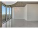 Spacious open living area with cityscape view, concrete ceiling, and access to balcony at 855 Peachtree Ne St # 2912, Atlanta, GA 30308