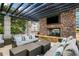 Cozy outdoor lounge with plush seating around a fireplace and TV, ideal for relaxing outdoors at 855 Peachtree Ne St # 2912, Atlanta, GA 30308