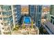 An aerial view of a pool surrounded by chairs and tables between buildings at 855 Peachtree Ne St # 2912, Atlanta, GA 30308