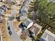 Aerial view of a suburban neighborhood showcasing a two-story home with mature trees at 1091 Dunedin Trl, Woodstock, GA 30188