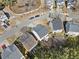 Aerial view of homes showing a concrete patio and mature trees in a suburban neighborhood at 1091 Dunedin Trl, Woodstock, GA 30188