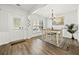 Bright dining area featuring a modern chandelier, wood floors, and natural light at 1091 Dunedin Trl, Woodstock, GA 30188