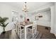 Dining area with wood floors, stylish table, and adjacent view into the kitchen at 1091 Dunedin Trl, Woodstock, GA 30188