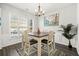 Dining area with wood floors, stylish table, and natural light from a nearby window at 1091 Dunedin Trl, Woodstock, GA 30188