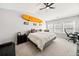 Bright main bedroom showcasing a comfortable bed, ceiling fan, and a surfboard as wall decor at 1091 Dunedin Trl, Woodstock, GA 30188