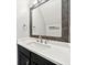 Modern powder room featuring a large mirror with dark trim, a white countertop, and dark cabinetry at 1091 Dunedin Trl, Woodstock, GA 30188