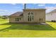 Back exterior showcasing well maintained lawn and expansive backyard at 1516 Montauk Pt, Conyers, GA 30013