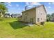 Expansive backyard featuring lush green lawn, mature trees, and a patio area at 1516 Montauk Pt, Conyers, GA 30013