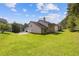Well-maintained backyard with a large green lawn and mature trees, offering ample space at 1516 Montauk Pt, Conyers, GA 30013